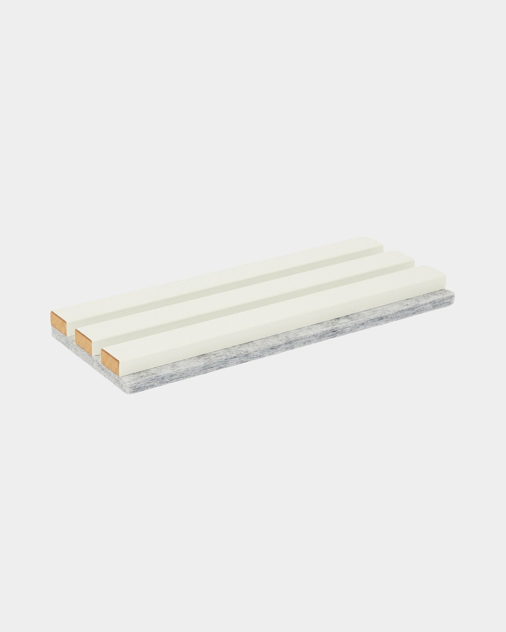 The Hue Sample / Snow by WoodUpp is a rectangular cleaning sponge with three white strips and a durable gray scrubbing layer, used for acoustic panel care.
